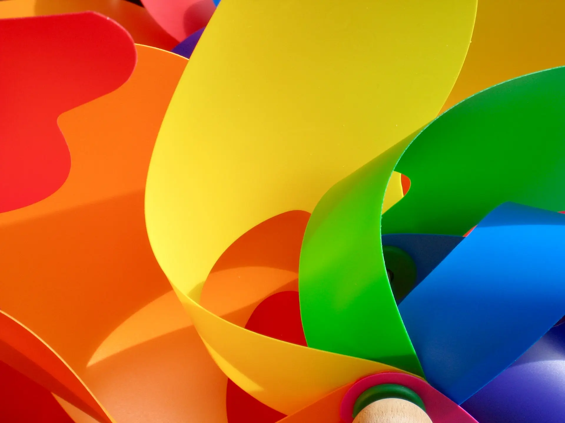 a bunch of different colored paper with a pencil in it